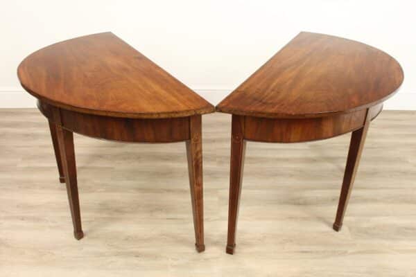 A Pair of Georgian Mahogany Semi Circle Console Tables