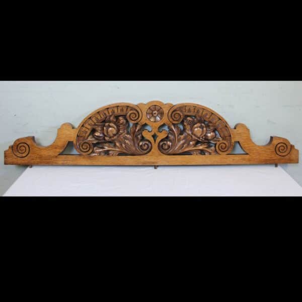 Antique Late Victorian Carved Oak Pediment. This lovely shaped late Victorian oak pediment has carved and scroll detail.