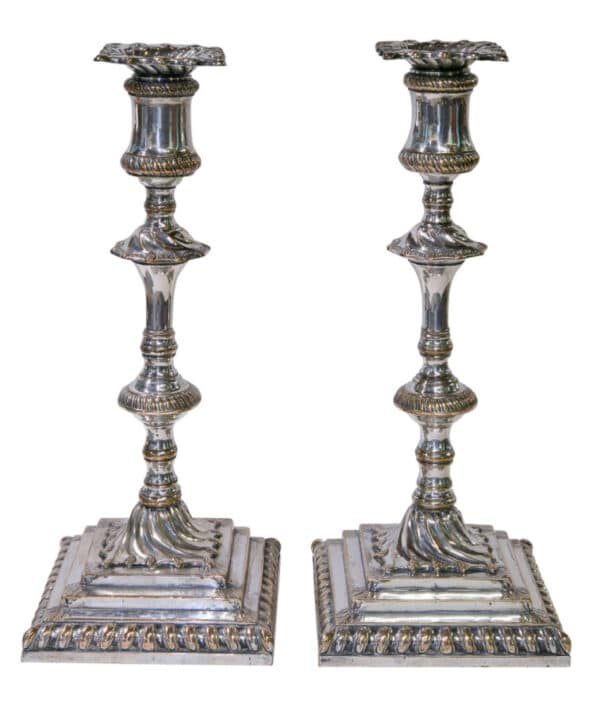 A superb pair of square based candlesticks