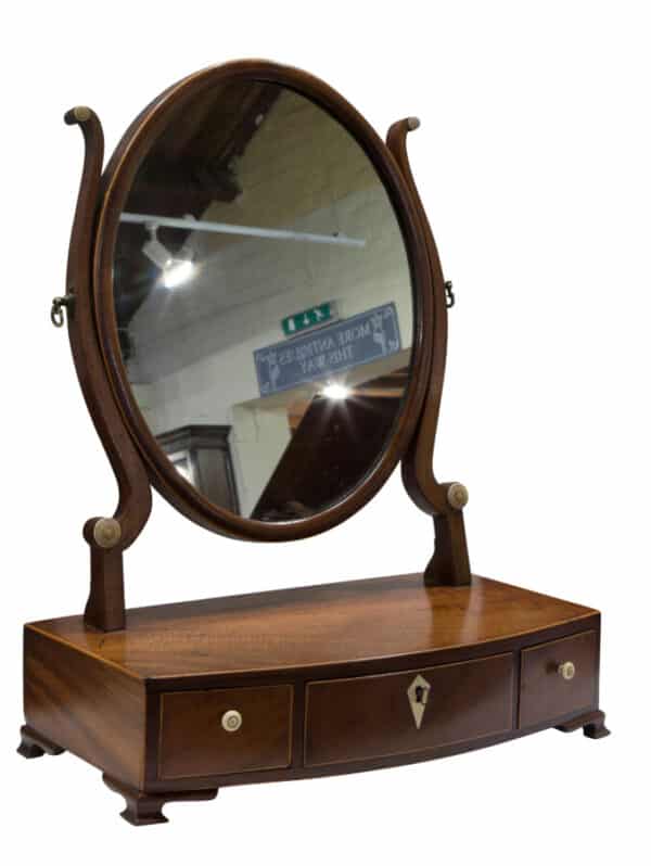 A Georgian Oval mahogany dressing table Mirror