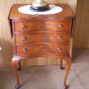 A SERPENTINE BEDSIDE CABINET WITH SIDE FLAPS Antique Furniture