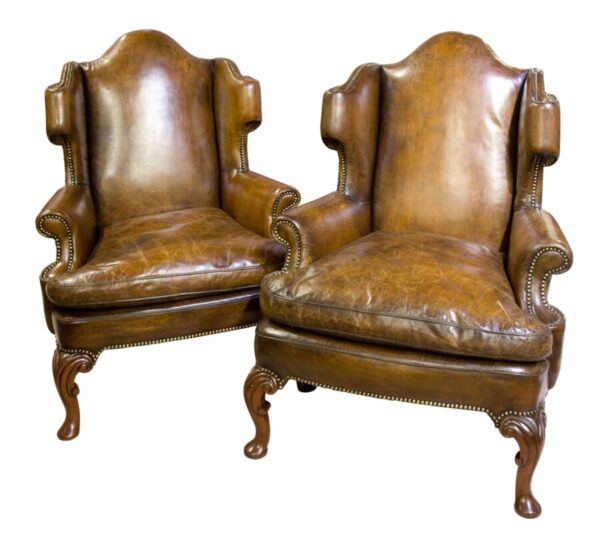 Pair of walnut and leather armchairs