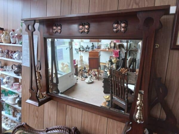 AN ART NOUVEAU OVERMANTEL MIRROR IN MAHOGANY