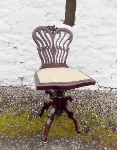 Edwardian mahogany Swivel chair. By Jas Shoolbred and Co. London.