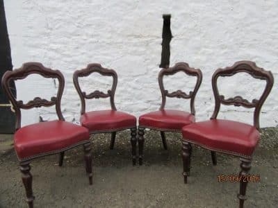 Set of four carved mahogany dining chairs