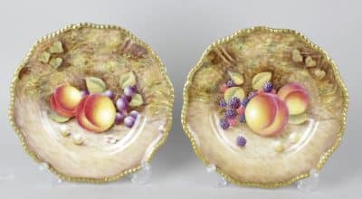SOLD A pair of Royal Worcester porcelain fruit-painted plates.