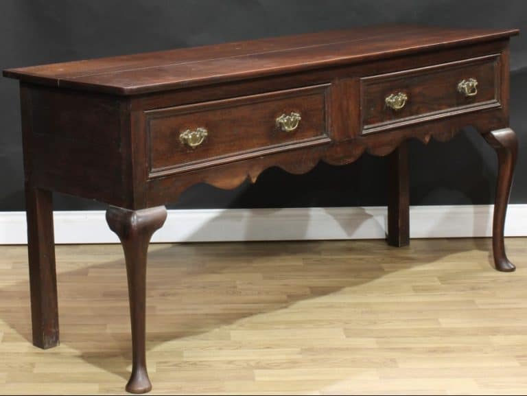 An 18th century revival oak low dresser