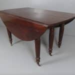 A Georgian extending drop leaf table. A Georgian extending drop leaf table Antique Tables
