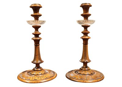 A Pair of Carved Walnut Candlesticks