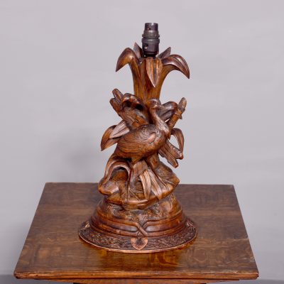 Rare Carved Black Forest limewood table lamp in a naturalistic scene