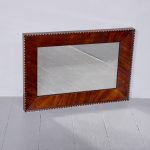 Unusual Victorian wall mirror in a figured mahogany frame with scalloped and gilded decorations wall mirror Antique Mirrors