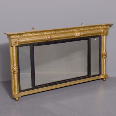 Neat-sized, Regency period gilded triptych overmantel mirror with acanthus decorated columns.