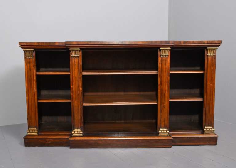 Rare breakfront Regency rosewood open bookcase with gilt decorated pilasters