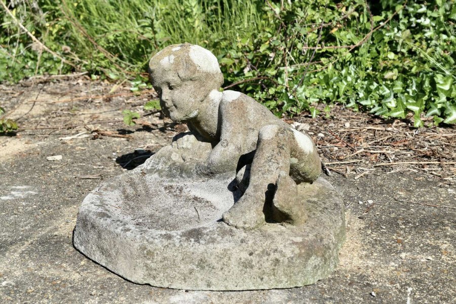 Weathered Garden Bird Bath with a Small Child