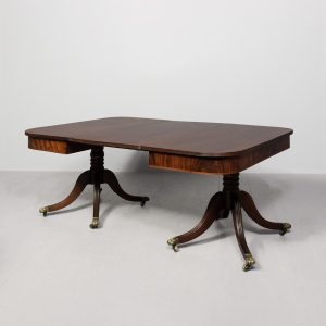 A Regency Mahogany Twin Pillar Dining Table and Extra Leaf.