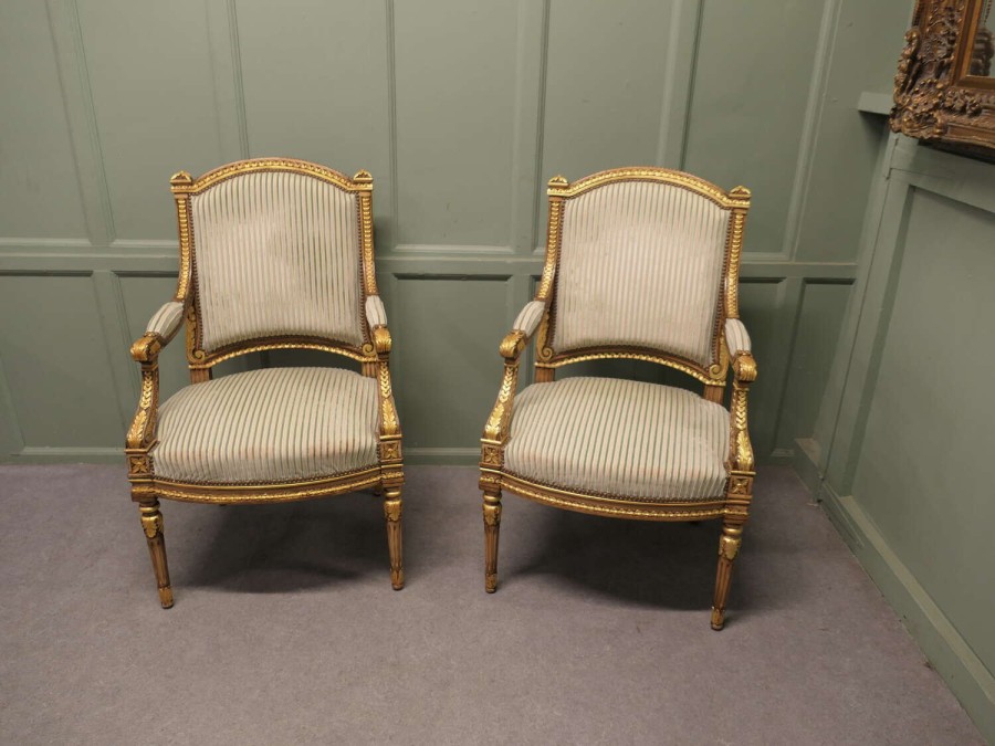 A Pair of French Regency Style Open Arm Chairs