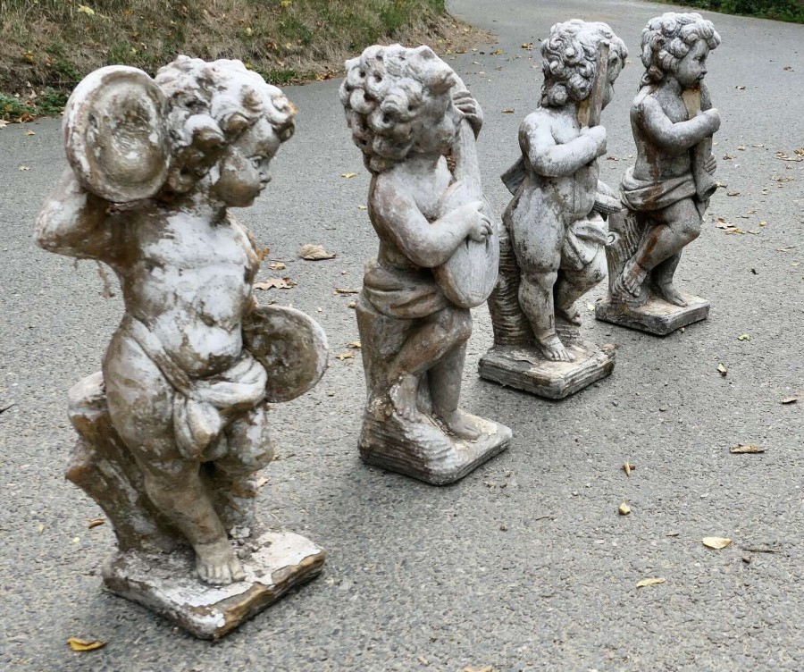 A Set of 4 Weather Worn Cherub Statues with Instruments