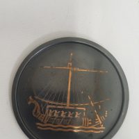 Copper relief plaque depicting an ancient sailing vessel