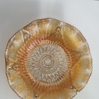 Marigold carnival glass bowl with ruffled rim and sunburst pattern