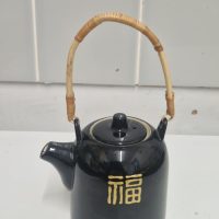 Ceramic teapot with bamboo handle and Chinese ‘Fu’ (福) character