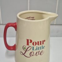 Ceramic pitcher with ‘Pour a Little Love’ text