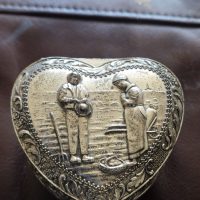 Silver-plated heart-shaped trinket box with embossed decorative motifs