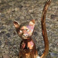 Brass cat figurine with rhinestone eyes and ring holder tail