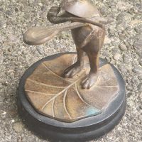 Bronze or brass frog figurine standing on lily pad base