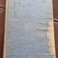 Hardcover book titled ‘The Adventures of Huckleberry Finn’ by Mark Twain, published by Dean &amp; Son Ltd.