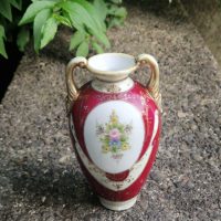 Porcelain vase with hand-painted floral decoration and gilded handles, likely Nippon or Noritake style