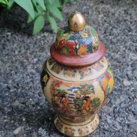 Hand-painted ceramic ginger jar with lid featuring traditional Asian motifs