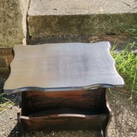 Wooden two-tier side table with shaped top and lower shelf