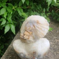 Hand-carved stone fire agate sculpture of a male figure