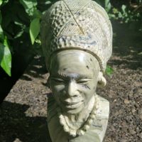Stone sculpture of an African woman with traditional headdress