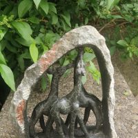 Hand-carved soapstone sculpture depicting a giraffe family under an arch, Zimbabwe Shona art