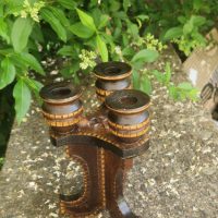 Carved wooden three-arm candelabra with inlaid bone or light wood decoration