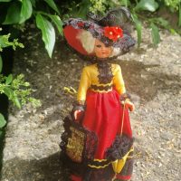 Vintage Belgian costume doll with sleep eyes, approximately 7.5 inches tall