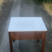 Mid-century modern nightstand or end table with white laminate top and walnut drawer front