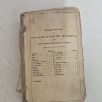shows an antique pocket-sized New Testament,