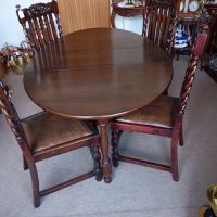 A WELSH DARK OAK DINING TABLE (FOLDING) OVAL SHAPE with 4 CHAIRS