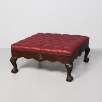 Exceptional quality, very large mahogany-framed Chippendale-style burgundy hide upholstered stool.