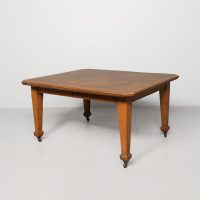 Late Victorian golden oak wind out table with two additional leaves, supported on square supports
