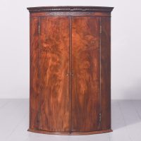 George III Bow-Front Figured Mahogany Hanging Corner Cupboard