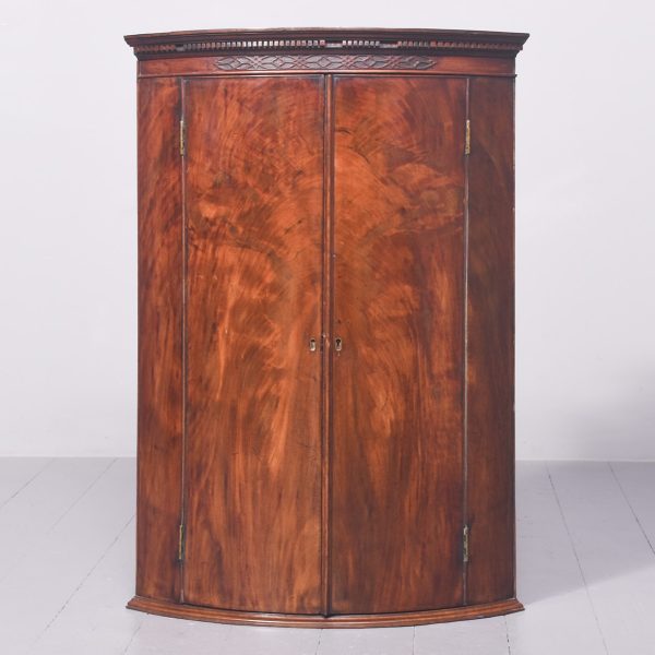 George III Bow-Front Figured Mahogany Hanging Corner Cupboard