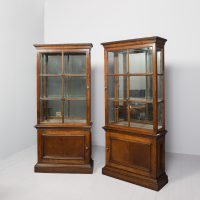 Rare pair of tall Neo-Classical style part-glazed display walnut cases