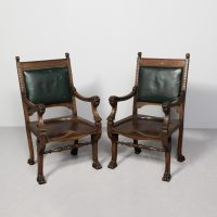 Pair of 19th-century Renaissance-style figured mahogany and green hide upholstered chairs