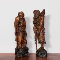 Pair of very tall Japanese Meji Period hardwood carvings of a warrior and an elder in long robes