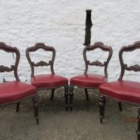 Set of four carved mahogany dining chairs