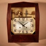 A French Art Deco Oak Signed Odo Automation Striking Wall Clock.
