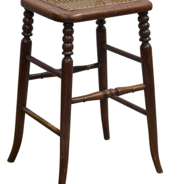A beech framed tall stool with caned top on slender turned legs